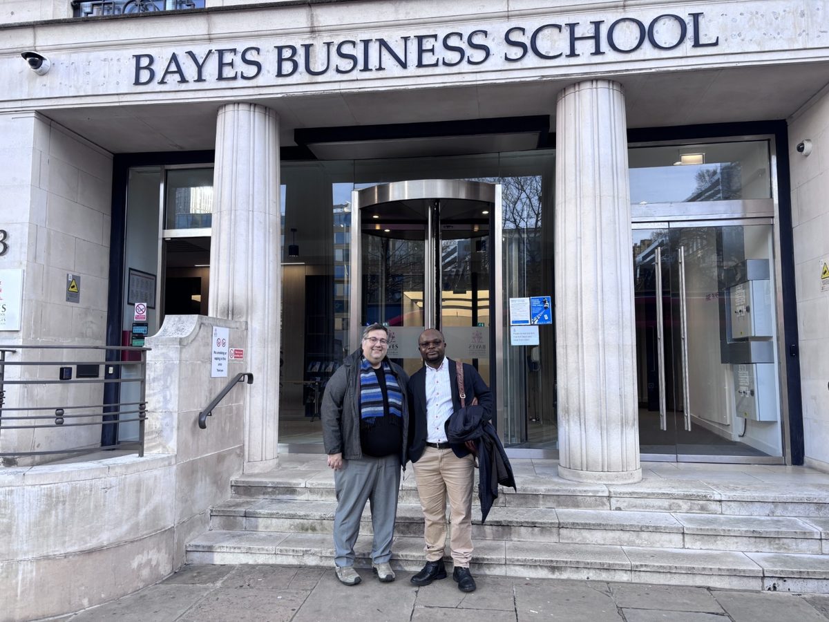 Dr Michael Selorm Avumegah outside the entrance to Bayes Business School in London